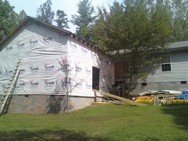 Tyvek wrapped gable on a new room addition beside an existing home in Otis